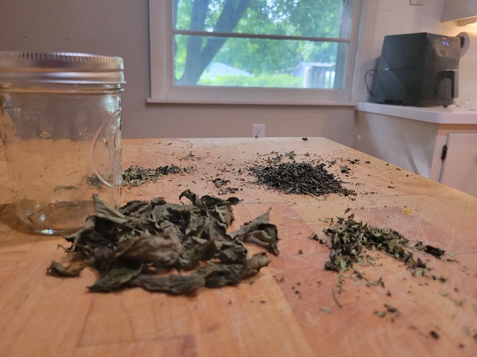 Dried herbs on butcher block from air fryer - mason jar for storage