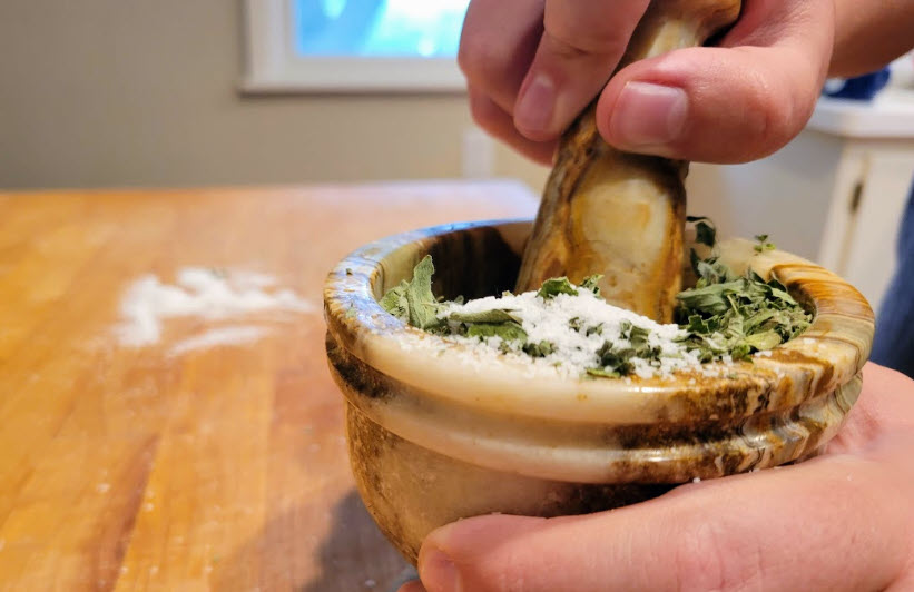 Oregano-infused salt with mortar and pestle