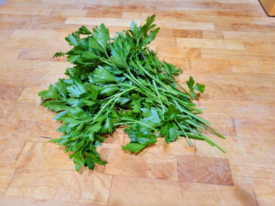 Bunch of Italian (flat-leaf) parsley on butcher block counter