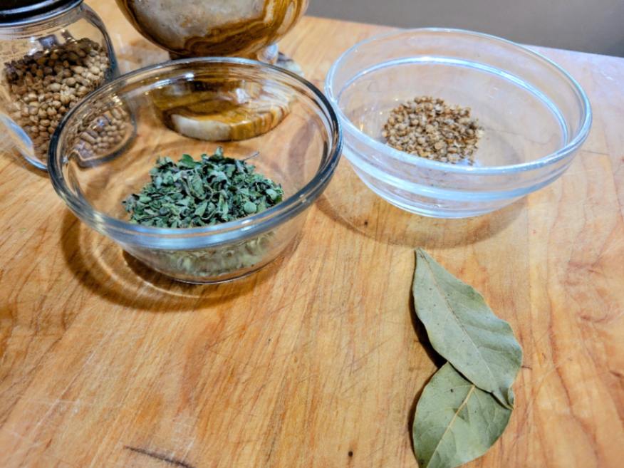 Coarsely ground coriander, oregano, and bay leaves: herbs for rustic chili